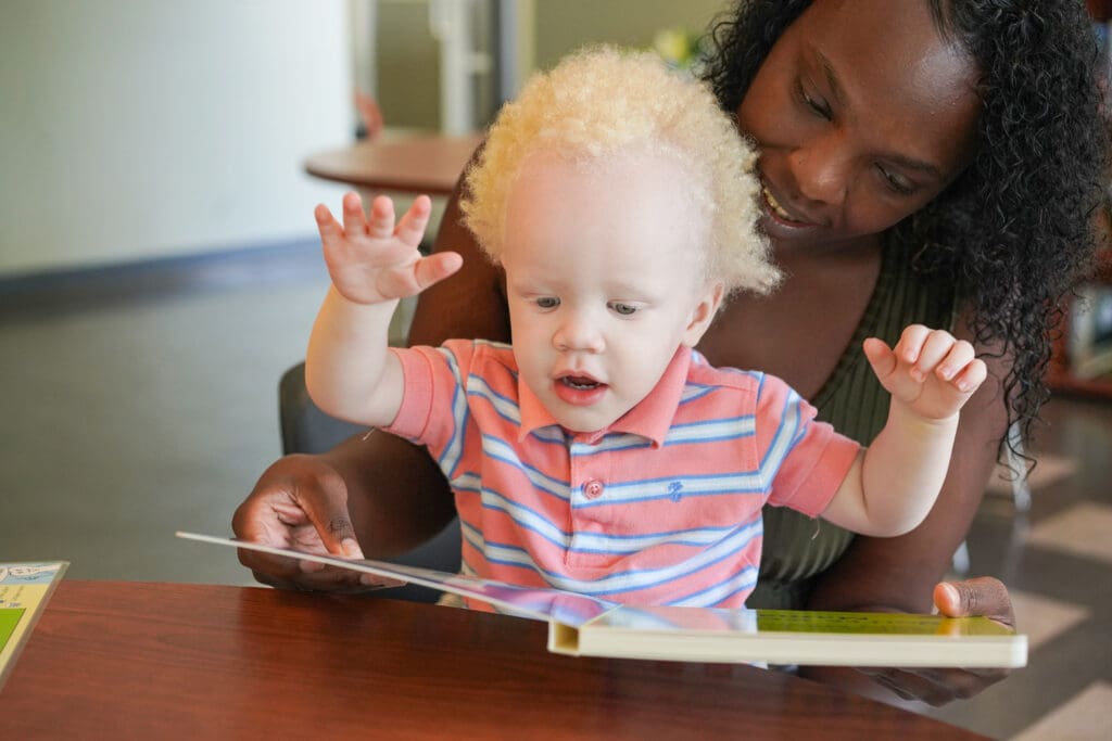 Mother and child reading a book together.