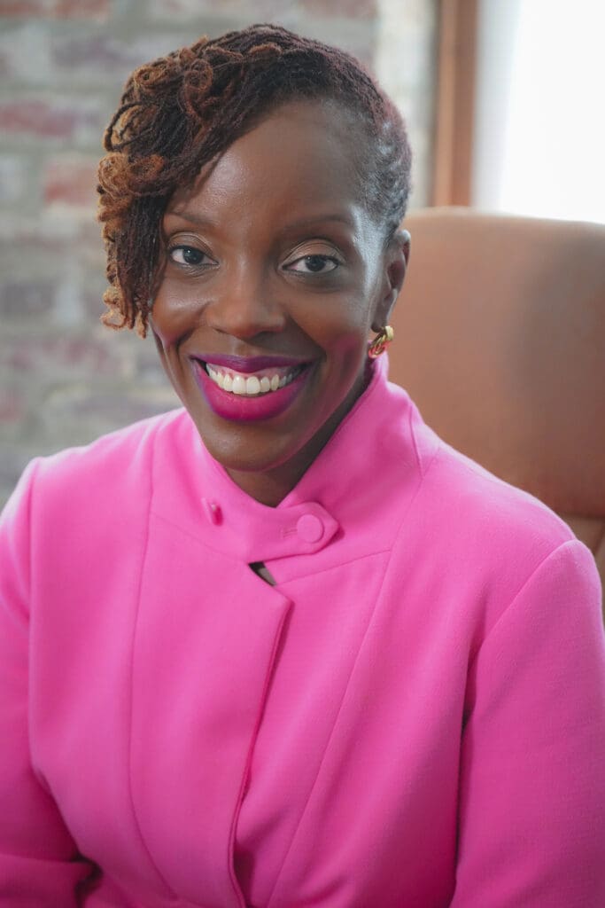 Springboard to Opportunities founder Aisha Nyandoro smiling in a pink suit jacket.